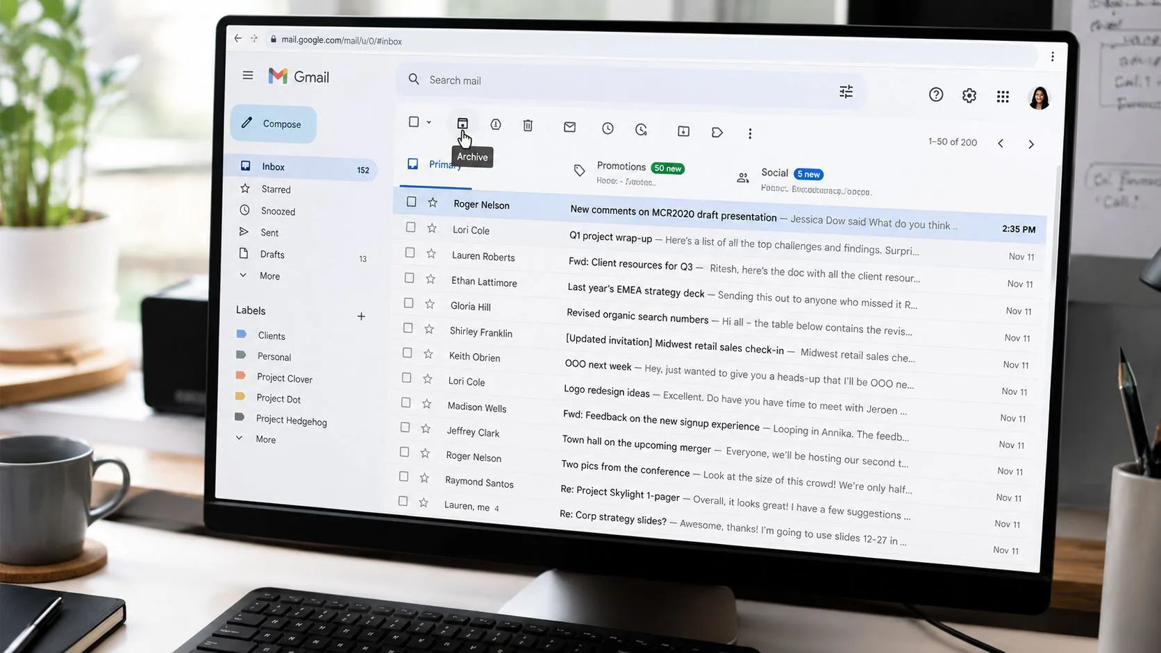 Computer screen displaying a Gmail inbox with an archive icon highlighted by a mouse cursor.