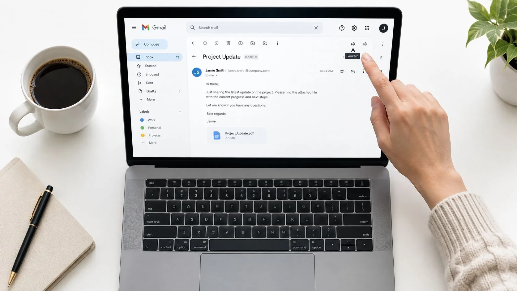 A person using a laptop to click the forward button on a Gmail message about project updates.