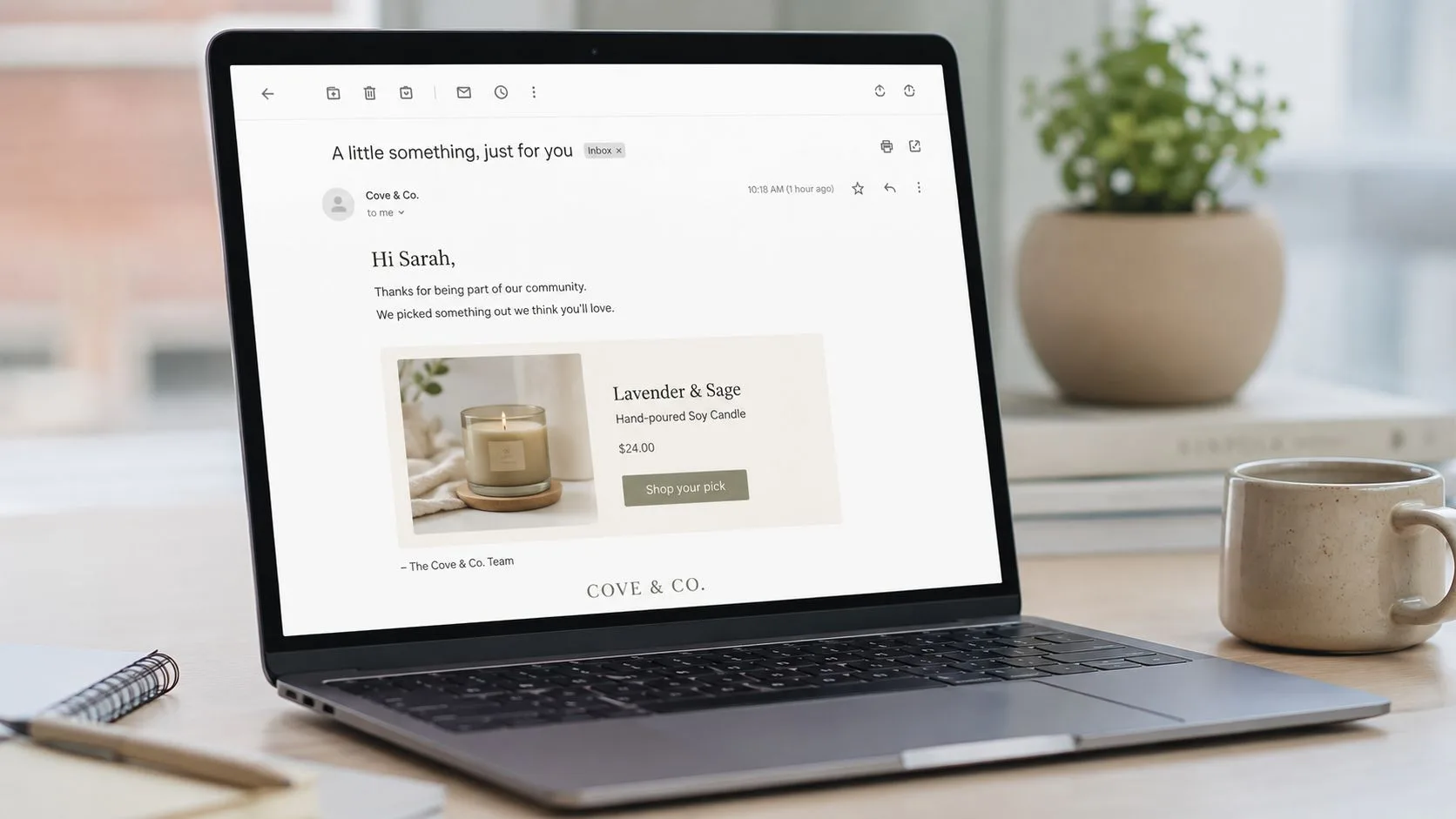 A laptop screen displaying a personalized marketing email from Cove & Co offering a soy candle product.